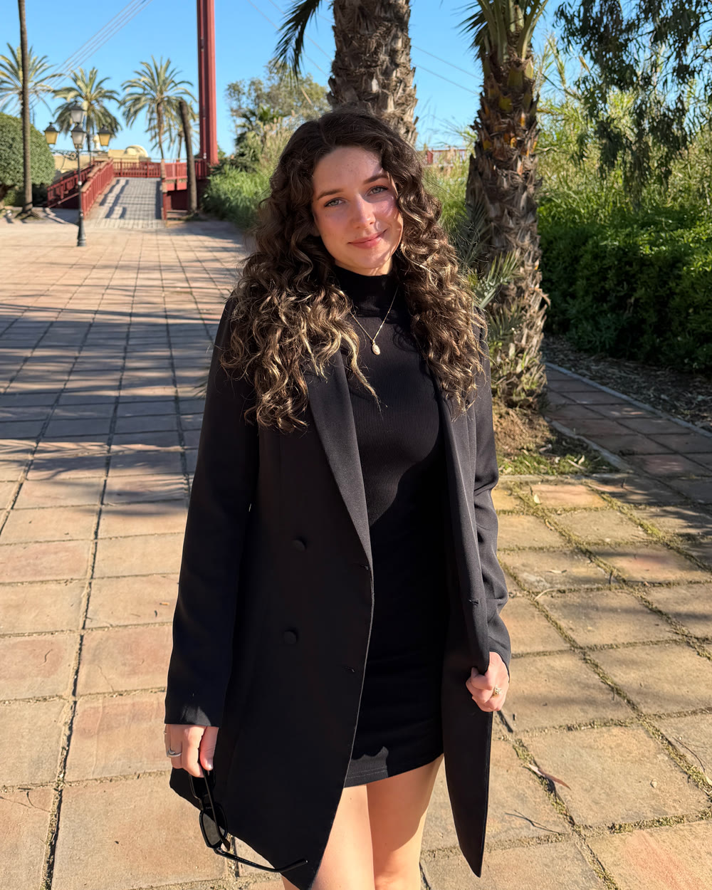 Hails standing under palm trees on a sunny day